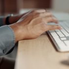 Woman hands typing on keyboard at night for email marketing, digital software editing and copywriting on desktop. Productivity of writer, editor or person working on computer at her office online job